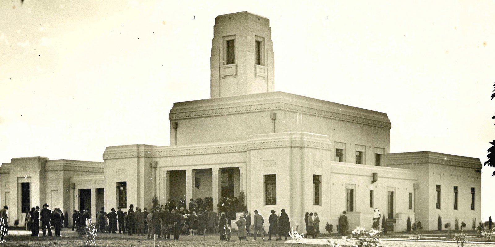 Historical photo of people gathered outside the Art Deco chapel and crematorium at Woronora Memorial Park.